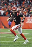  ?? AP Photo/Jeff Dean ?? ■ Cincinnati Bengals quarterbac­k Joe Burrow (9) looks to throw during the first half of an NFL wild-card playoff football game Saturday against the Las Vegas Raiders in Cincinnati.