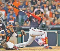  ?? DAVID J. PHILLIP ASSOCIATED PRESS ?? The Nationals’ Juan Soto hits a tworun scoring double during the fifth inning of Game 1 of the World Series against the Astros on Tuesday in Houston.