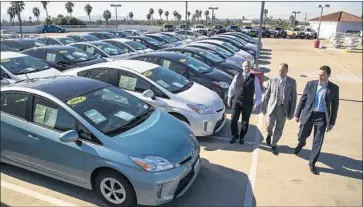 ?? Gina Ferazzi Los Angeles Times ?? ROGER HOGAN, center, with Roger Hogan Jr., left, and Stephen Hogan, has refused to sell 70 used Toyota Priuses on his family’s lots and has warned customers about what he says is a safety hazard in those models.
