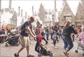  ?? Al Seib
Los Angeles Times ?? CROWDS GROW as the first members of the public enter the Wizarding World of Harry Potter attraction at Universal Studios Hollywood on Thursday.