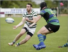  ??  ?? Andy Roberts gets his pass away during the clash with Seapoint.