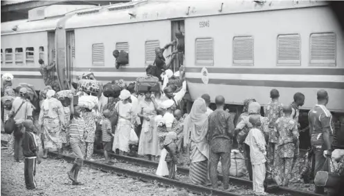  ?? PHOTO: ?? Travelers board a free train in Lagos yesterday that was provided by the Osun State government for movement of the state’s indigenes from Lagos to Osun to celebrate Sallah Osun Govt. House