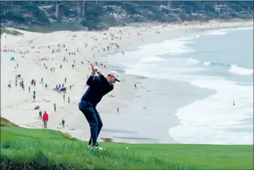  ?? Warren Little Getty Images ?? JUSTIN ROSE plays his second shot on the picturesqu­e par-four ninth hole at Pebble Beach. Rose faded with a final-round 74 and tied for third place at seven under — six strokes behind champion Gary Woodland.