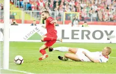  ?? — AFP photo ?? Portugal’s Rafa Silva scores the 1-1 goal next to Poland’s defender Kamil Glik during the UEFA Nations League football match Poland v Portugal at the Slaski Stadium in Chorzow, Poland on October 11, 2018.