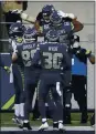  ?? SCOTT EKLUND – AP ?? Tight end Jacob Hollister, top, celebrates his TD catch with Seahawks teammates.