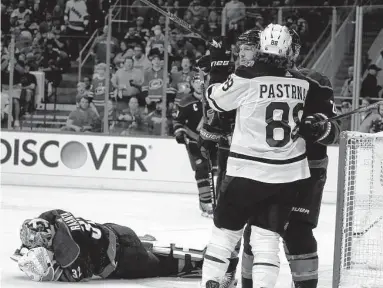  ?? Karl B Deblaker / Associated Press ?? The Bruins’ David Pastrnak (88) tangles with the Hurricanes’ Ian Cole in front of injured goaltender Antti Raanta during Game 2 on Wednesday in Raleigh, N.C. Pastrnak struck Raanta in the head with a gloved hand.