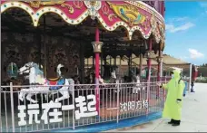  ?? PROVIDED TO CHINA DAILY ?? A staff member of Shenyang Fantawild Adventure disinfects the merry-go-round area. The theme park in Shenyang, Liaoning province, is scheduled to reopen on April 1.