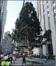  ?? — JULIE WALKER/AP ?? Workers move the 2018 Rockefelle­r Center Christmas tree into position yesterday.