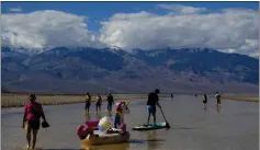  ?? TY ONEIL — THE ASSOCIATED PRESS ?? A paddle boarder tows an inflatable unicorn Friday in Death Valley.