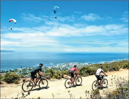  ?? Cyclists ride along a dirt road above the sea in Hermanus.
PICTURE: CHERIE VALE/ NEWSPORT MEDIA ??