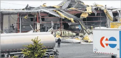  ?? JOE GIBBONS/THE TELEGRAM ?? The front wall and roof of Trimac National Tank Services in the Donovans Business Park after Tuesday morning’s explosion.