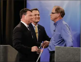  ?? AP Photo/Darron Cummings, Pool ?? GOP: In this April 30, 2018, photo, Senate candidates from left, Todd Rokita, Luke Messer and Mike Braun speak with each other following the Indiana Republican senate primary debate in Indianapol­is. As primary season kicks into high gear, Republican­s are engaged in nomination fights that are pulling the party to the right, leaving some leaders worried their candidates will be out of a step with the broader electorate in the November election.