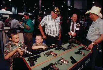  ??  ?? Beretta handguns at an NRA convention, San Antonio, Texas, April 1991