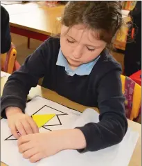  ??  ?? Young Caoimhe pictured doing tangrams on Friday in Douglas NS.