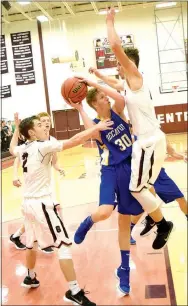  ?? Photo by Mike Eckels ?? Sandwiched between two Gentry defenders, Decatur’s Ryan Ross (30) tries to put up a jumper late in the third quarter of the nonconfere­nce basketball game at Pioneer Gym in Gentry on Nov. 20.