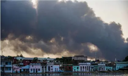  ?? Photograph: Yamil Lage/AFP/Getty Images ?? Smoke rises from the massive fire at a fuel depot in Matanzas, Cuba.