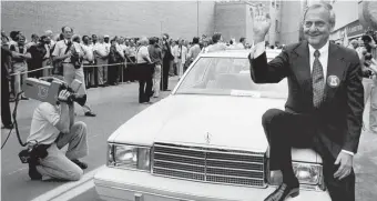  ?? AP FILE ?? ‘HE WAS A LEADER’: Chrysler Corp. Chairman Lee Iacocca sits on the fender of K-Car Number One, a Plymouth Reliant, in 1980.