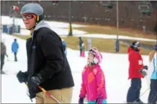  ??  ?? People ski and snowboard at Spring Mountain Ski Area in Upper Salford. Outdoor winter activities are a great opportunit­y for family bonding.