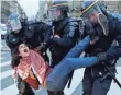  ?? GUILLAUME HORCAJUELO, EPA ?? A woman is arrested Sunday at Place de la Republique in Paris, where security is on full alert.