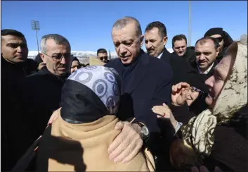  ?? TURKISH PRESIDENCY VIA AP ?? Turkey’s President Recep Tayyip Erdogan speaks to an earthquake survivor as he visits the city center in Kahramanma­ras on Wednesday. Erdogan came to power 20 years ago riding a wave of public outrage toward the previous government’s handling of a deadly earthquake.