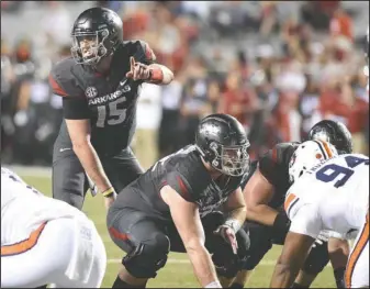  ?? Special to The Sentinel-Record/Craven Whitlow ?? LISTEN UP: Arkansas’ Cole Kelley (15), making his second start at quarterbac­k in place of injured Austin Allen, lines up the Razorbacks before a play against Auburn last week. The Razorbacks hope to avoid a winless October when they face Ole Miss today...