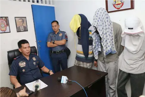  ?? Chris Navarro ?? BUY BUST. San Simon Chief of Police Chief Inspector Louie Gonzaga questions three suspected pushers who were arrested during a buy bust operation in Barangay Sta. Monica, San Simon yesterday. The three yielded six kilos of dried marijuana leaves with a street value of P 240,000. -