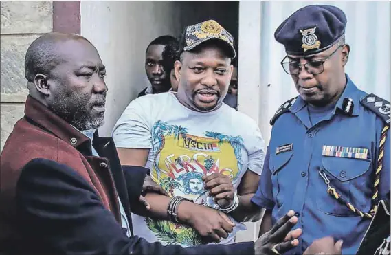  ?? Photos: Afp/getty Images & Yasuyoshi Chiba/afp/getty Images ?? Making a splash: The former governor of Nairobi, Mike Sonko (centre), after he was arrested for alleged economic crimes in 2019; Sonko’s supporters hold up a T-shirt during a parade in 2018 (below left); volunteers from the Sonko Rescue Team, a privately funded NGO, fumigate a street (below right) to curb the spread of Covid-19 during a joint operation with Nairobi County during the 7pm to 5am curfew at a residentia­l area in the city in April last year.