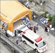  ?? KYODO NEWS ?? Rescue crews work outside a facility for the handicappe­d where at least 15 were killed and dozens hurt in a knife attack early Tuesday in Sagamihara, Japan.