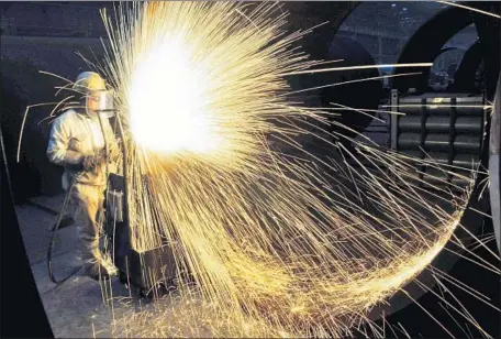  ?? AFP/Getty Images ?? A STEELWORKE­R in China, which has been hit by U.S. tariffs on solar panels, steel and aluminum and may incur additional ones.