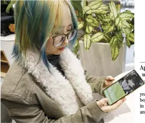  ?? JADE GAO/AGENCE FRANCE-PRESSE ?? OFFICE worker Wang Xiuting shows her virtual boyfriend on Wantalk, an artificial intelligen­ce chatbot created by Chinese tech company Baidu, on her phone at a cafe in Beijing.