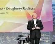  ??  ?? Pat Riley, chairman of the board of LeadingRE, announces one of the awards won by John Daugherty, Realtors.