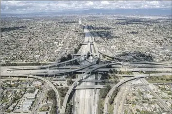  ?? Photograph­s by Robert Gauthier Los Angeles Times ?? TRAFFIC WAS light on the 110 and 105 freeways even as rush hour neared amid the COVID-19 lockdown in March 2020. One expert calls 2020 “an outlier” that “cannot be used as a reliable data point.”