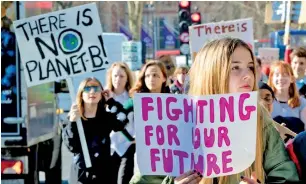  ?? (Image credit: Shuttersto­ck) ?? A group of students carry signs protesting climate change inaction.