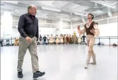  ??  ?? Terrence S. Orr, left, artistic director of Pittsburgh Ballet Theatre, and principal dancer Luca Sbrizzi work on a rehearsal for “Giselle” at Pittsburgh Ballet Theatre in the Strip District.