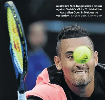  ?? / GREG WOOD / AFP PHOTO ?? Australia's Nick Kyrgios hits a return against Serbia's Viktor Troicki at the Australian Open in Melbourne yesterday.