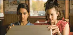  ?? FOCUS FEATURES ?? Geraldine Viswanatha­n, left, and Margaret Qualley star in “Drive-Away Girls.”