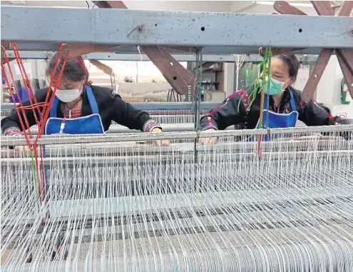  ??  ?? USEFUL SKILLS: Villagers from Doi Tung, Chiang Rai learn weaving at Doi Tung Vocational Training Centre, set up to help the community.