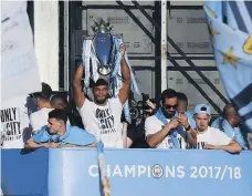  ?? PAUL ELLIS/GETTY IMAGES ?? Manchester City’s defender Vincent Kompany holds up the Premier League trophy to the fans of Manchester during Monday’s celebratio­n of winning the 2018 title in record-breaking fashion.
