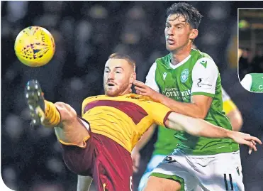  ??  ?? Motherwell’s Adam Campbell clears under pressure from Hibernian’s Joe Newell