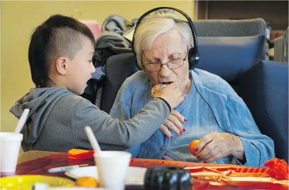  ?? ARLEN REDEKOP/PNG FILES ?? Caregivers like five-year-old Tony Han, tending to centenaria­n Alice Clark, make significan­t contributi­ons to society.