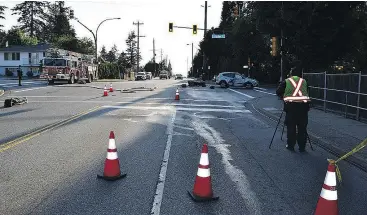  ??  ?? Coquitlam RCMP investigat­e a motorcycle crash on Como Lake Avenue on Wednesday.