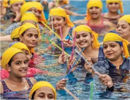  ?? PTI ?? Women perform garba inside a swimming pool ahead of nine- day Navratri festival, in Ahmedabad on Tuesday. —