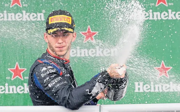  ??  ?? DUTCH DELIGHT: Red Bull driver Max Verstappen, of the Netherland­s, celebrates on the podium after winning the Brazilian Grand Prix