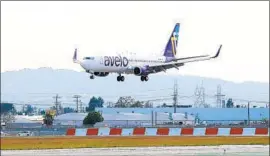  ?? Joe Scarnici Getty Images for Avelo Air ?? AN AVELO plane lands at Hollywood Burbank Airport on Wednesday. Despite the pandemic, “this is an incredible time” to launch an airline, Avelo’s CEO says.