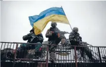  ?? Photo: REUTERS ?? Flagging their intentions: Ukrainian soldiers are refusing to let their guard down after separatist rebels violated the fragile ceasefire.