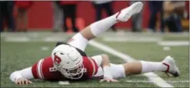  ?? JULIO CORTEZ — THE ASSOCIATED PRESS ?? Rutgers quarterbac­k Artur Sitkowski looks on from the turf after being tossed while throwing a pass against Penn State during the first half.