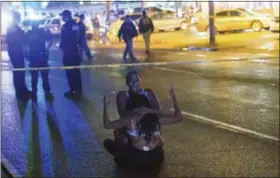  ?? MATTHEW HINTON — THE ADVOCATE VIA AP ?? People react at the scene of a shooting in New Orleans, Saturday.