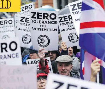  ?? TOLGA AKMEN / AFP / GETTY IMAGES ?? Protesters hold up signs and flags as they gather for a rally organized by the Campaign Against Anti-Semitism outside the head office of Britain’s Labour Party in London earlier this year. British police announced on Friday they are investigat­ing alleged anti-Semitic hate crimes within the party.