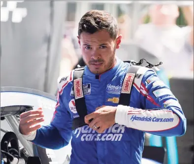  ?? Darron Cummings / Associated Press ?? Kyle Larson walks in his garage during practice for a NASCAR Cup Series auto race at Indianapol­is Motor Speedway on Saturday.