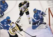  ?? FRANK GUNN — THE ASSOCIATED PRESS ?? Boston’s David Krejci (46) scores the tying goal past Tampa Bay goaltender Andrei Vasilevski­y during the third period Monday. The Lightning won in OT to win the series.